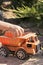 A child plays in the sand with big toy cars, an excavator, a truck