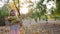 Child plays with soap bubbles in sunlight, happy little girl laughing at autumn