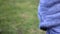 A child plays with sticks in a park