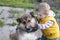 A child plays with a stray animal.