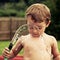 Child plays with water hose