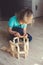 A child plays with a wooden constructor. Home games. Early Childhood Development