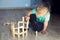 A child plays with a wooden constructor. Home games. Early Childhood Development