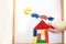 Child plays wooden magnetic educational game. girl plays with a toy on a white background