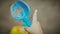 A child points with his finger into the distance in his hand he has a blue scoop for the earth