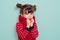 Child portrait of a 6 year old brunette, blue eyes, funny hairstyle wearing a red scarf and sweater, 