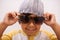 Child, portrait and sunglasses with smile and confidence with kid in a home. Happy, eyewear and youth fashion with an