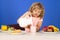 Child pouring milk, studio isolated portrait. Kid boy drink dairy milk.