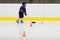 Child practices stickhandling at ice hockey practice