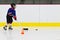Child practices stickhandling at ice hockey practice