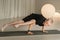 A child practices yoga poses indoors. Children& x27;s yoga
