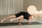 A child practices yoga poses indoors. Children& x27;s yoga