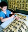 A child practicing Chinese calligraphy carefully