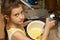 Child preparing cookies in kitchen.