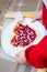 The child is preparing a pizza with berries. raspberry and straw