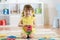 Child preschooler girl plays logical toy learning shapes and colors at home or nursery
