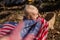 A child pulls the flag of America behind him. Flag of America in the hands of a toddler girl. Flag Day. Army Day