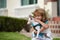 Child with puppies hugging. Funny child playing with dog outdoor.