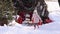 A child puts gifts in a sleigh at Christmas.