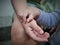 The child puts his hand on his mother\'s hand. love and bond. Babies are safe around their mothers.