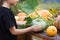 Child puts orange pumpkin . autumn harvest time in garden.