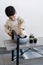 Child putting soil in flower pot.