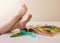 Child putting their feet up after successfully coloring a picture in a book.