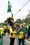 Child raises the Brazilian flag high on his father`s shoulder