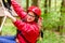 Child reaching platform climbing in high rope course