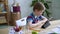 Child read lesson information on tablet, homeschooling boy sit at desk and study online Spbas.