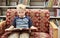 Child reading a book on a couch at the library