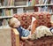 Child reading a book on a couch at the library