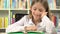 Child reading, studying in library, student girl learning at desk office 4K