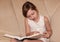 A child reads a thick encyclopedia. The baby is reading a book in close-up
