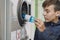 Child recycling plastic bottles in a machine