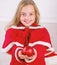 Child red costume hold christmas ornament ball. Kids can brighten up christmas tree by creating their own ornaments