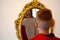 The child reflected in a distorting mirror. A fun reflection of the boy. Children`s entertainment