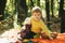 Child relax in autumn nature. Autumn picnic with teddy bear. Dreamy kids face. Daydreamer child portrait close up