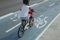 Child riding a bike on bicycle lane or cycle path outdoors