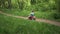 Child riding a toy car in the forest park