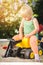 Child riding on a toy tractor on playground