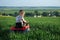 A child is riding on a tractor on a meadow.