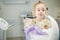 Child rinses out mouth and sits in dentist chair