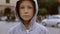 Child on the road against a background of blurry cars