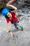 child rock climber gives a high five after passing the track. kids sport and activity