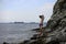 Child on a rocky shore of the black sea