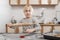 Child with rolling pin in his hands rolls out the cookie dough. Cooking with children in kitchen