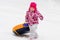 Child rolls down snow hill