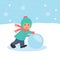 The child rolls a snowball. Walk outdoors in winter holidays