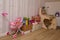 Child room for girl, desk, chair, toys, toy boxes, baby doll stroller, childish wallpaper. Girls room